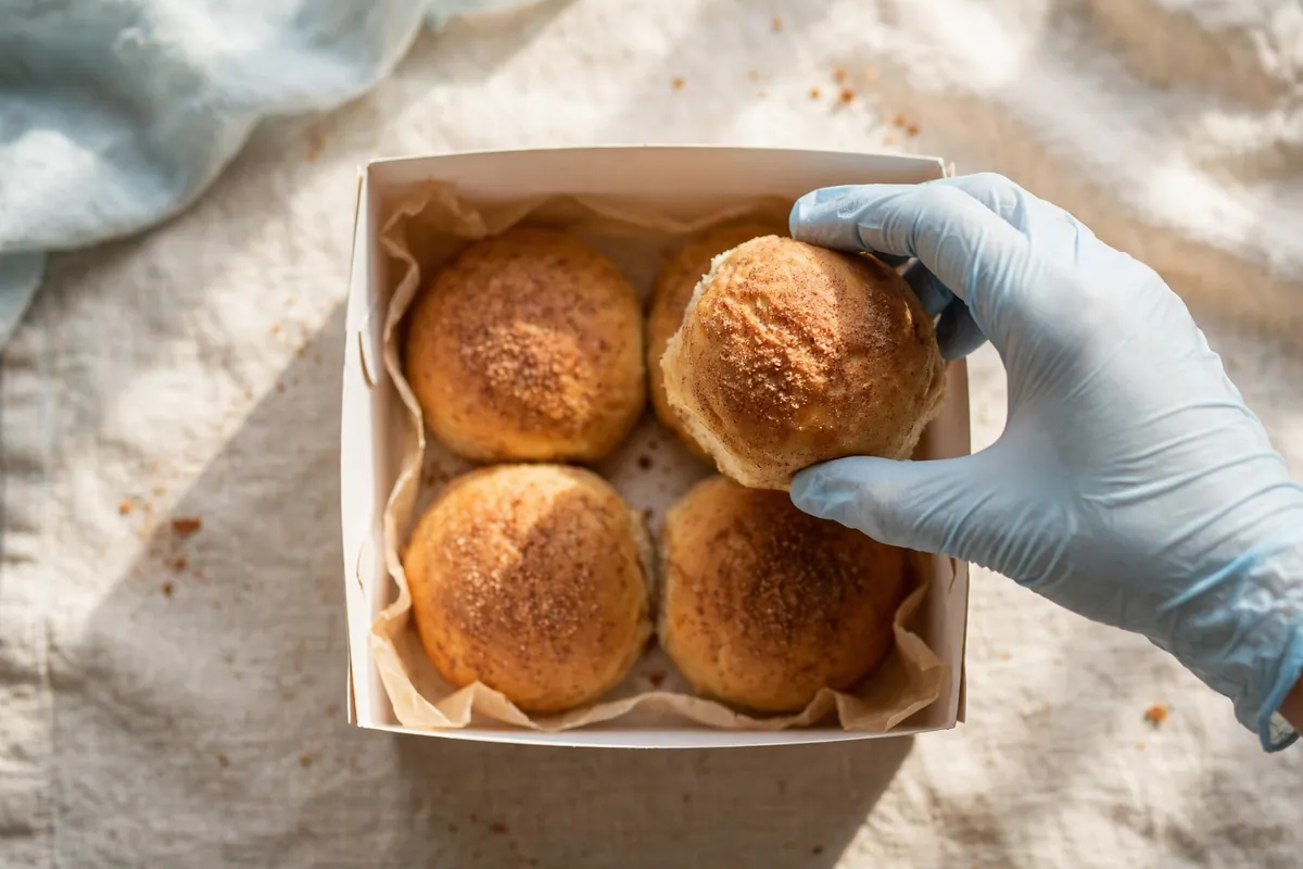 Buns being placed in a white box